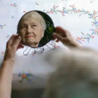 Elderly woman refection in a mirror