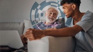 Young carer talking to elderly man
